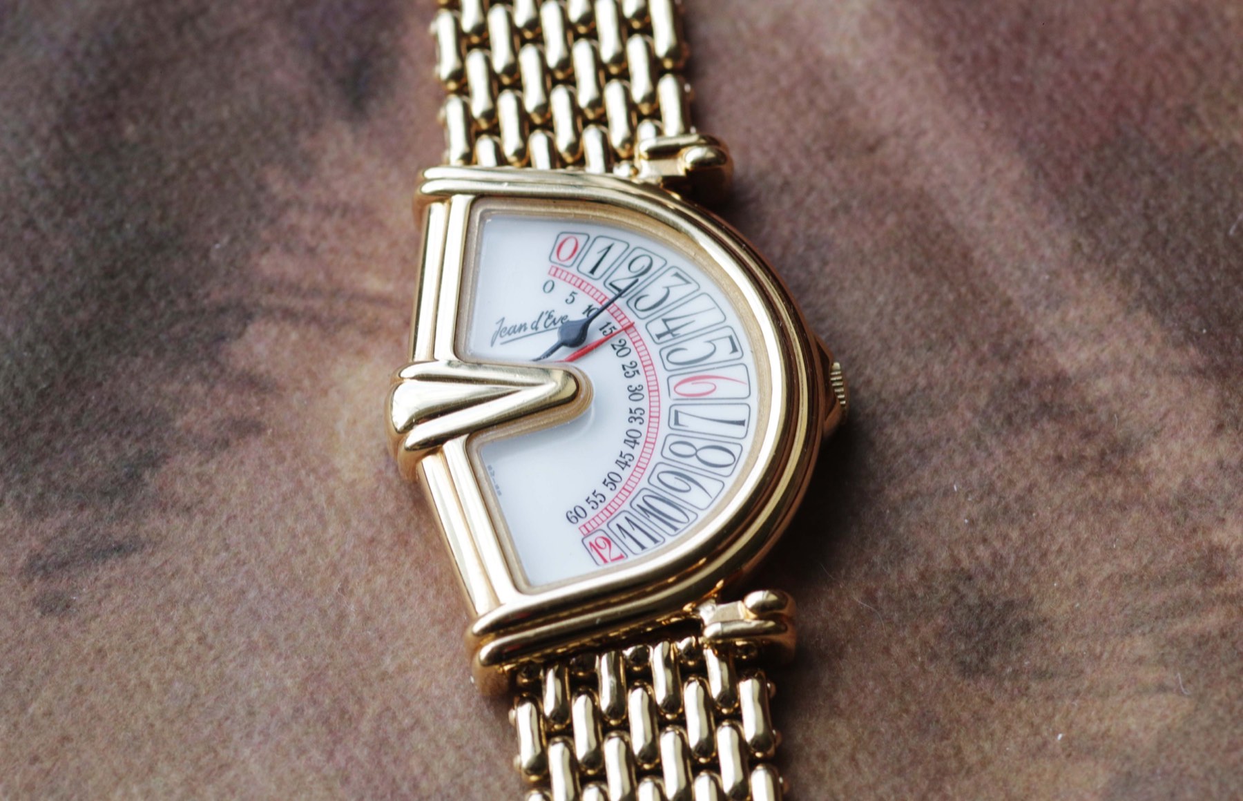Jean d’Eve Sectora with a white sector dial and gold-tone integrated bracelet